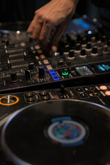 Close-up of a DJ Instructor's Hands Demonstrating Mixing Techniques on a Professional DJ Controller...