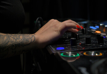 Close-up of a DJ Instructor's Hands Demonstrating Mixing Techniques on a Professional DJ Controller at a Music Workshop