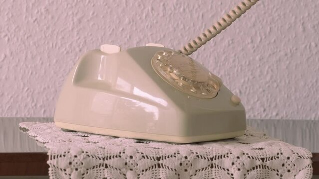 mature male hand removing Handset, rotating Dialer on Old white Rotary Telephone with Disc Dial with finger, putting retro phone reciver down, hanging up, calls helpline, psychological support