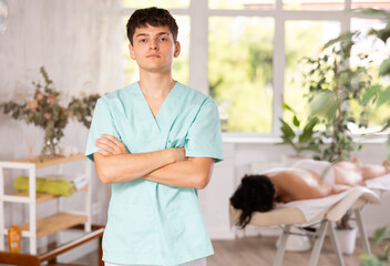 Portrait of friendly male masseur in spa salon