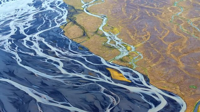Aerial view of braided rivers in Iceland, showcasing the intricate patterns and stunning natural beauty of Iceland's unique landscapes.