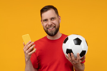 Close up studio portrait of happy smiling young man posing over bright colored yellow background...