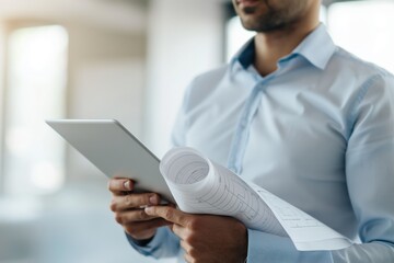 Focused architect comparing construction plan on paper with digital tablet, seamlessly integrating traditional and modern tools in architecture. Dynamic scene captures innovation in architecture