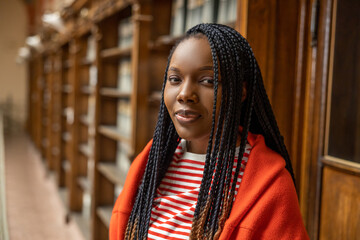 Portrait of a long-haired african american young woman in the library
