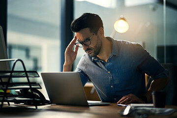 Thinking, stress and business man on laptop for internet, research and review in office....