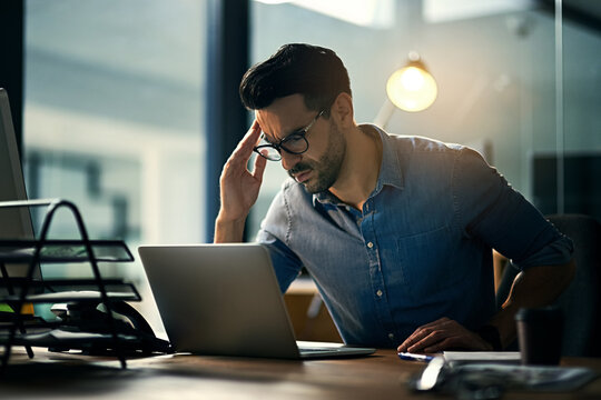 Thinking, stress and business man on laptop for internet, research and review in office. Consultant, working late and frustrated person with burnout on computer for planning, website and online