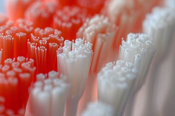 Detailed and close-up image of toothbrush bristles in a mix of red and white, emphasizing the texture and structure against a muted background.. AI generated.