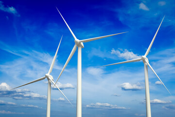 Fototapeta premium Green renewable energy concept - wind generator turbines in sky