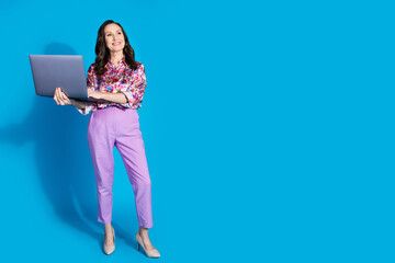 Photo of gorgeous retired lady wear trendy clothes hold netbook look empty space isolated on blue color background