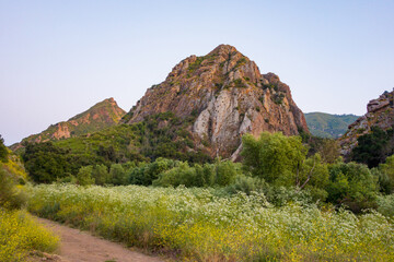 Views of the rough and rocky terrain, with the lush foliage, along with the creek, at Malibu Creek...