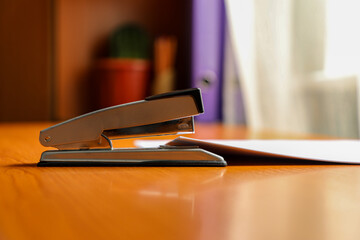 Stapler and papers on the accountant's desk close-up