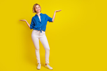 Full body portrait of pretty young lady hold empty space scales wear shirt isolated on yellow color background