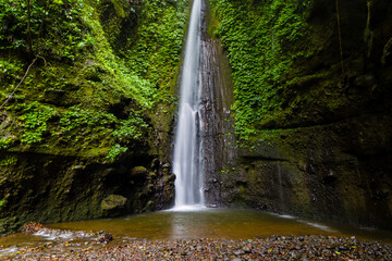 A tall waterfall in a tropical rainforest in Lombok, Indonesia
