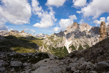 Obraz premium Hiking through Dolomite Mountains is surreal experience, surrounded by jagged peaks and serene landscapes.