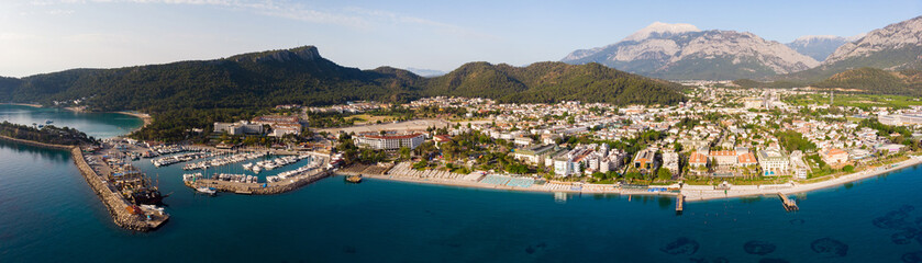 Fototapeta premium Panoramic photo of Kemer, resort town on Mediterranean coast of Turkey. City on Turkish Riviera from above.