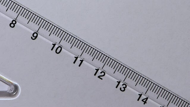 Close-up pencil drawing a 30 degree angle line across a plastic Set Square white paper copy space 