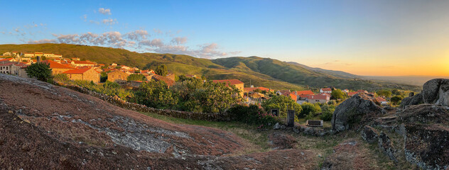 Panoramic view of a quaint town at sunset with surrounding hills. Linhares da Beira - Portugal.