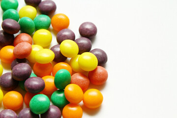 Close up shot of chewy colorful candy on white background