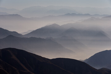 The Andes Mountains shrouded in fog create a mystical and ethereal atmosphere. As the mist weaves...
