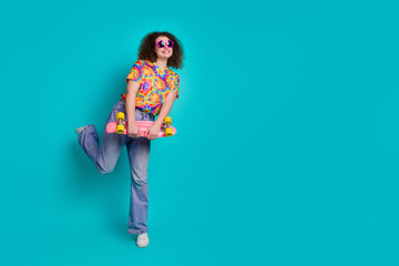 Photo of funky funny cheerful woman wear trendy print clothes look empty space isolated on cyan color background