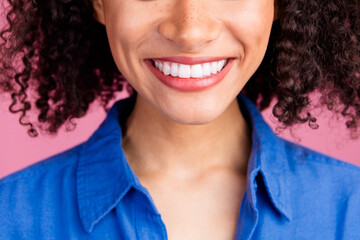 Cropped photo of adorable nice woman smiling showing white healthy teeth isolated on pink color...