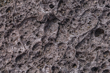 Vesicular texture is a volcanic rock texture characterized by a rock being pitted with many cavities (known as vesicles) at its surface and inside.  Hawaii Volcanoes National Park, 1969 Lava Flow 