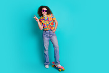 Photo of adorable lovely woman wear trendy print clothes have fun v-sign good mood isolated on cyan color background