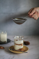 Banoffee cake with banana, whipping cream and caramel sauce filling sprinkled with grated dark chocolate on top