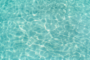 Up view photo of still transparent turquoise surface of the water of the swimming pool	