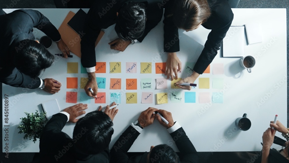 Aufkleber top down aerial view of manager discuss and choose marketing idea from sticky notes. group of busine