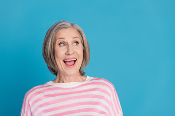 Photo portrait of lovely pensioner lady look excited empty space dressed stylish striped garment...