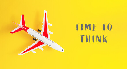 A small airplane is on a yellow background with the words Time to Think