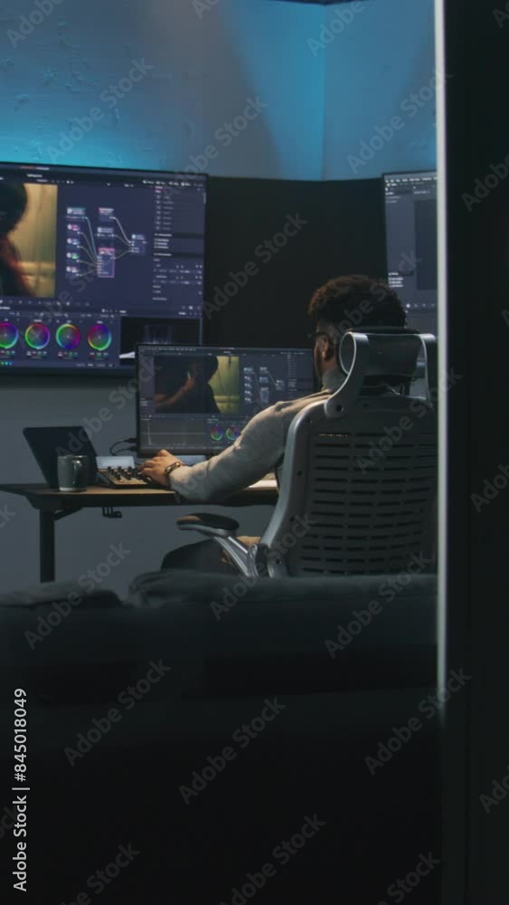 Poster professional african american video editor makes color grading in program on pc. process of colour c