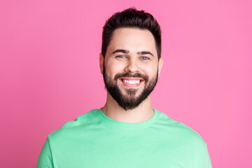 Photo of positive cheerful hansome nice guy with stylish beard dressed green t-shirt toothy smiling...