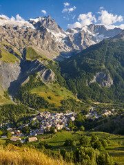 Fototapeta premium La Grave village in Ecrins National Park with view of La Meije peak and glacier in summer. Part of the famous GR 54 mountain treck. Hautes-Alpes, Alps, France