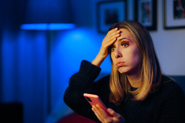 Woman Checking her Phone Feeling Desperate and Unhappy. Forgetful person feeling unhappy and worried 
