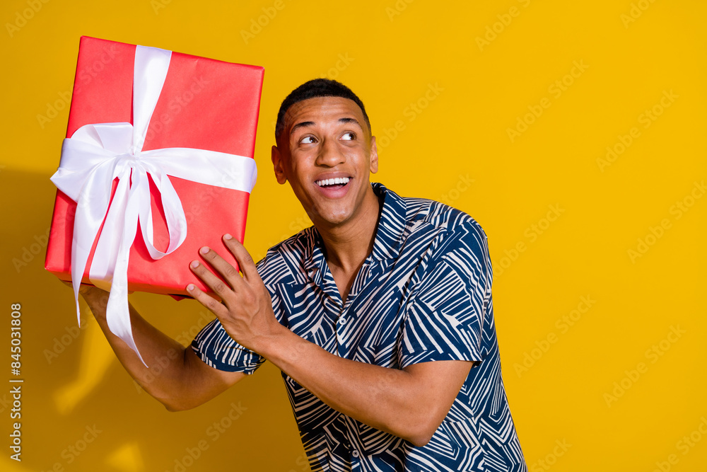 Canvas Prints Photo of cheerful positive guy dressed print shirt preparing valentine day gift look empty space isolated yellow color background