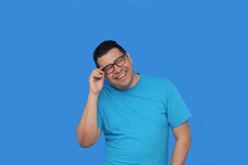 Fototapeta premium A 40-year-old dark-skinned Latino man uses eyeglasses to see better because he suffers from myopia and astigmatism in the vision of his eyes