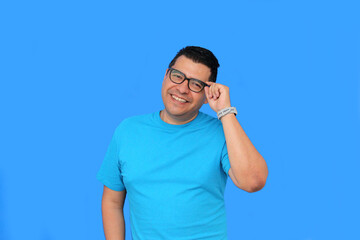 Fototapeta premium A 40-year-old dark-skinned Latino man uses eyeglasses to see better because he suffers from myopia and astigmatism in the vision of his eyes