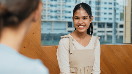 Young student smiling while listening other student in meeting or group discussion. Cute teenager...