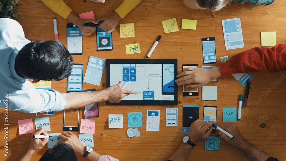 Poster top down view of business team writing idea on sticky note while planing for ux ui design for mobile