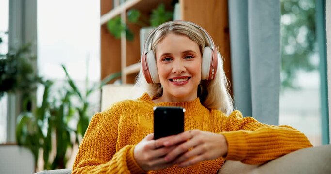 Girl, face and headphones with phone on sofa for audio streaming, social media scroll or listening to podcast. Woman, person and portrait with smartphone on couch for relax, ebook or happy with radio