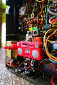 toy robot made of electronic components, boombox interior electrical components machine background