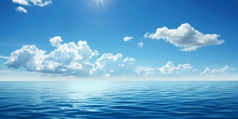 A picture of a clear blue sky with fluffy white clouds over a calm blue ocean