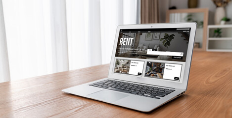 Online real estate rental search snugly on computer. House home or apartment rental website online.