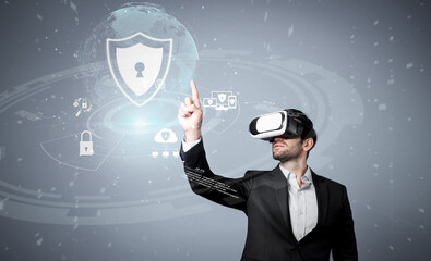 Caucasian project manager wearing VR glasses while look at hologram of security system. Smart...