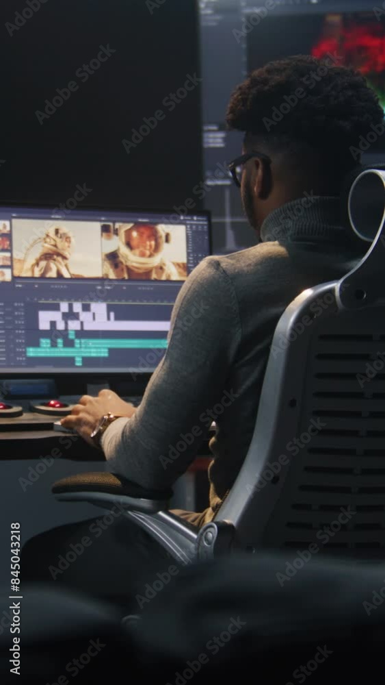 Aufkleber african american colorist makes color grading in video editing software. multiple monitors with spac