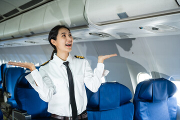 A female pilot in a blazer with epaulettes leans forward in the passenger seat of the airplane cockpit, checking the flight plan before takeoff, ensuring all pre-flight checks are complete.