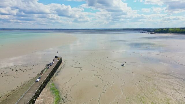 Cale de la Fenetre pier and beach during low tide, Brittany in France. Aerial forward