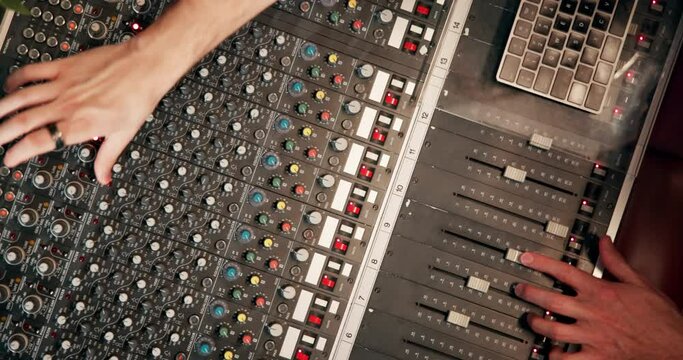 Studio, hand and person with music mixer for volume level, frequency change and control. Producer, sound engineer and audio equipment for track record, consistency and creativity with settings